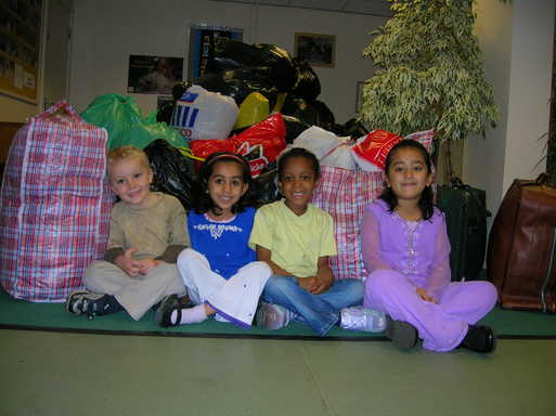 Mathew Webb, Juwariah Waseem, Briana Davis and Maqaddas Zahoor from Firshill reception class, with just a few of the bags of donated clothes and blankets.