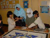 Children working together to create a large mosaic