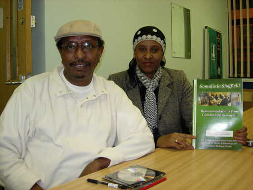Ahmed and Yasmin with a copy of the report .