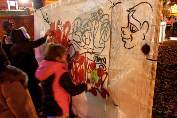 Children creating a graffiti mural