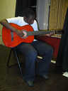 A member of SADACCA's study support group playing guitar