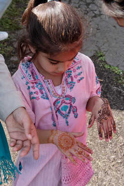Young girl with henna hands.