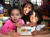 L-R, Freya Naylor (3) Sharon Curtis and Milan Curtis (3) proudly display their Pathways to Quality plaque.