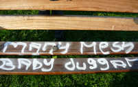 Vandalism on brown bench