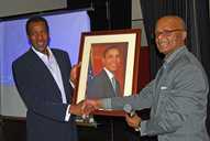Des Smith receives a portrait of Barack Obama from Mr Allen
