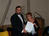 Councillor Hussain awarding certificate to Di Blyth-Browne