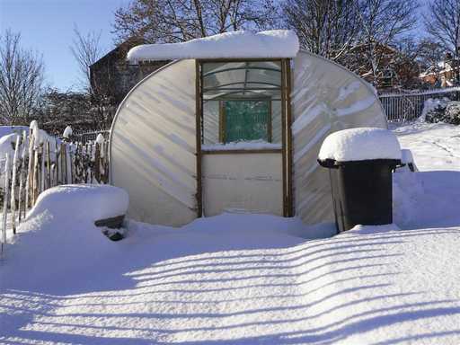 A snow-covered greenhouse