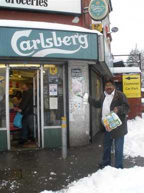 Rameshlal Patel in the snow outside Burngreave Wine Shop