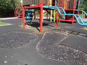 The soft surfaces of Denholme Close playground are full of holes and badly patched.