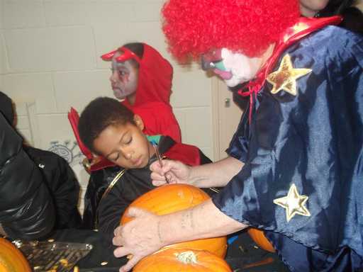 Clown carves the pumkin