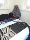 Somali Day Care Group member shows the embroidery skills she's learned