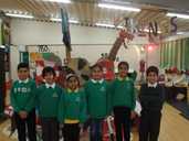 Children in school uniform stood in front of homemade viking longship.